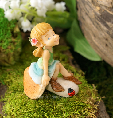 Garden pixie sitting on a mushroom image 0