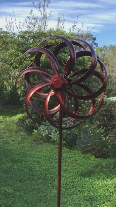 Copper coloured round metal windmill