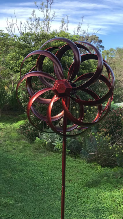 Copper coloured round metal windmill