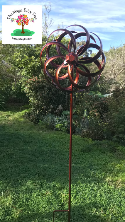 Copper coloured round metal windmill